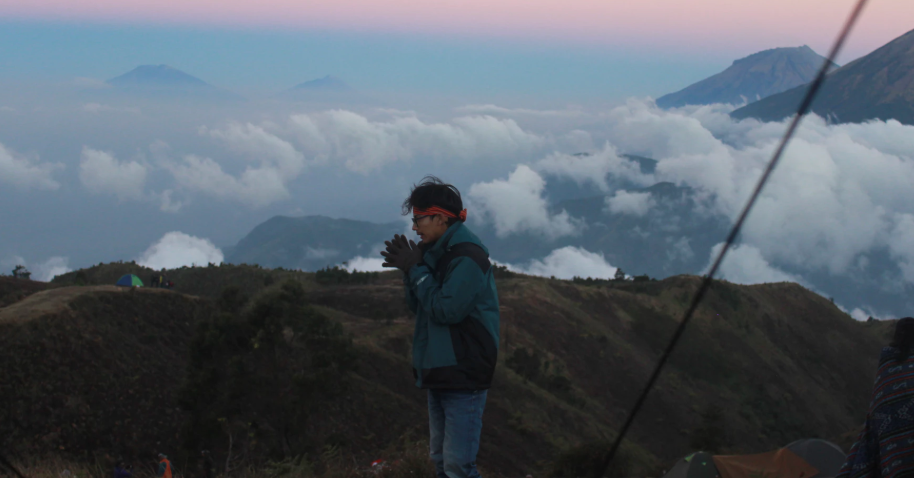 Man standing at the top of the mountain